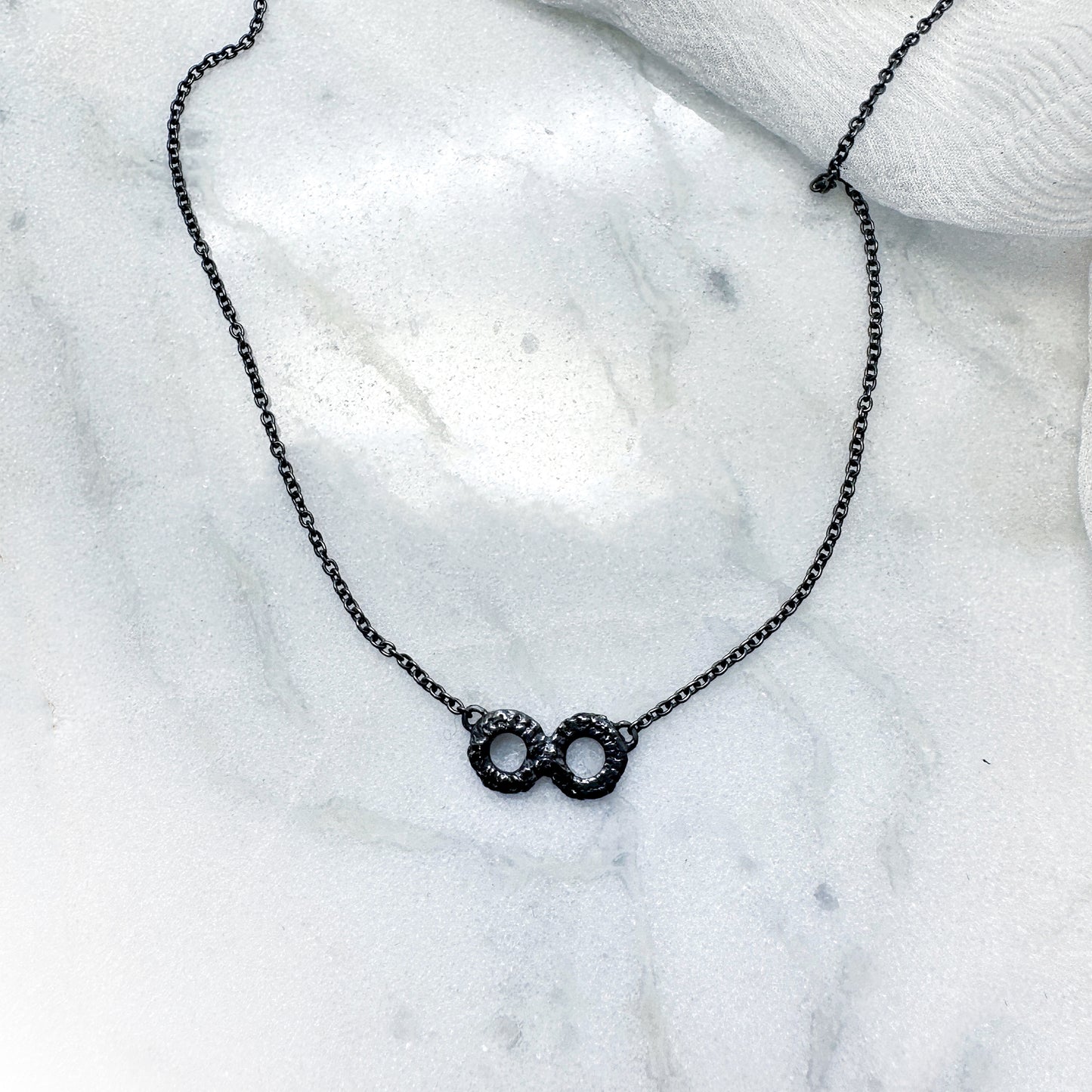 Infinity necklace in oxidised silver