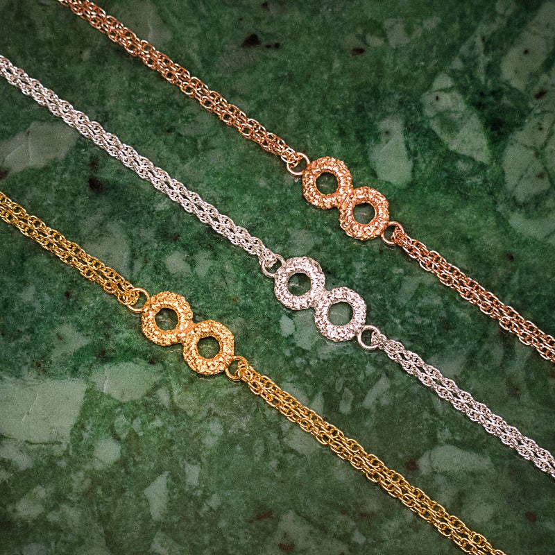 silver, rose gold and yellow gold infinity bracelets